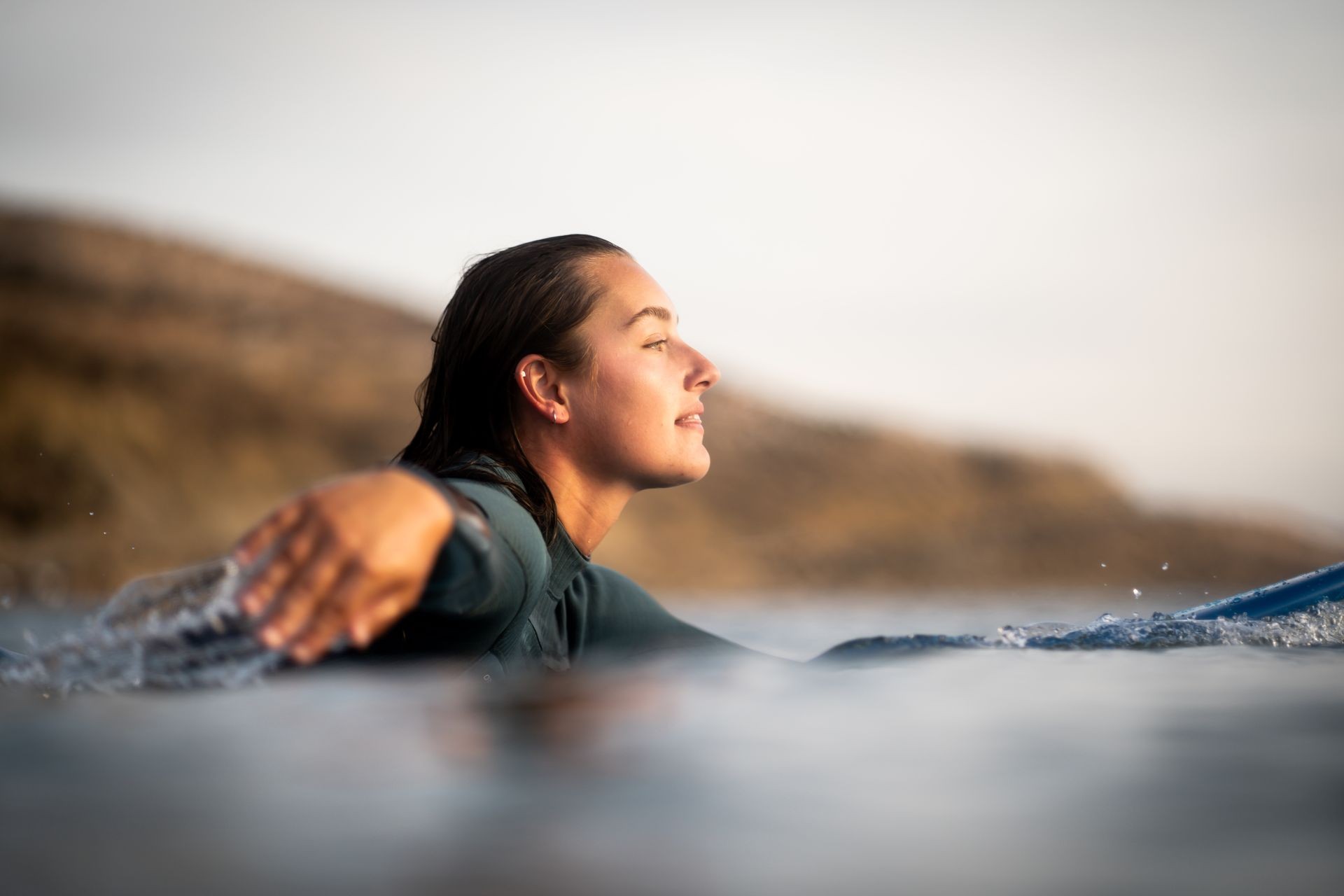 stunning image capturing a girl on a surfboard in Taghazout, watching the colorful sunset. Photo by med_lebsat.